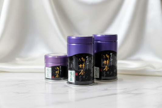 KANBAYASHI SHUNSHO - AYA NO MORI 100G BAG displayed in elegant cans on a marble surface.